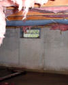 Arkansas crawl space with vents, showing mold, rot, and fiberglass insulation dripping off the ceiling.