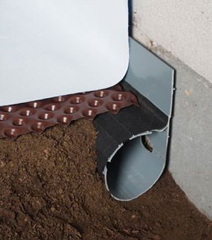 Closeup of a crawl space drainage system installed in North Little Rock