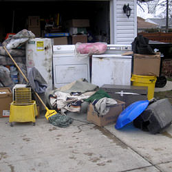 Soaked, wet personal items sitting in a driveway, including a washer and dryer in Greenbrier.