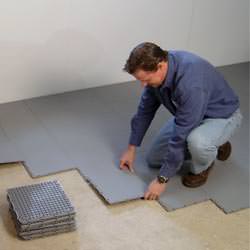 basement subfloor tiles being installed by a contractor in Woodson