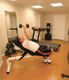 a basement gym and workout room with a wood laminate flooring, installed in Alexander, AR