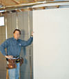Installing wall panels on top of our basement wall insulation in Greenbrier